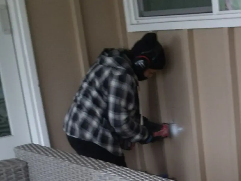 Professional electrician installing an exterior outlet in Woodcrest
